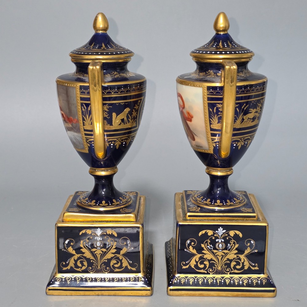 A pair of cobalt blue and gold Vienna porcelain Empire amphora vases featuring hand-painted classical figures and square plinth bases. View XII