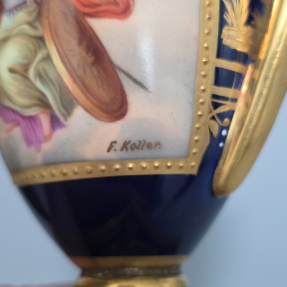A pair of cobalt blue and gold Vienna porcelain Empire amphora vases featuring hand-painted classical figures and square plinth bases. View II