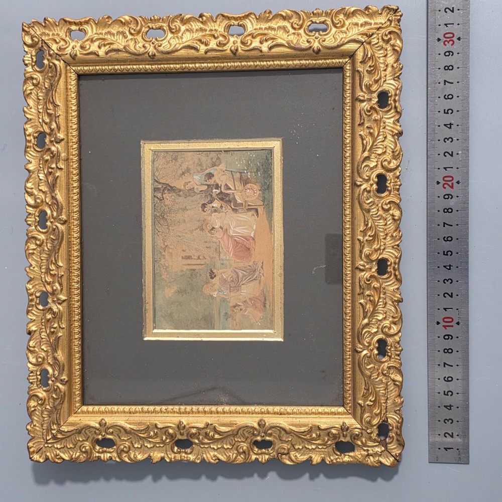 A pair of rectangular antique gilt-framed pictures featuring figurative genre scenes set against dark matting. View V