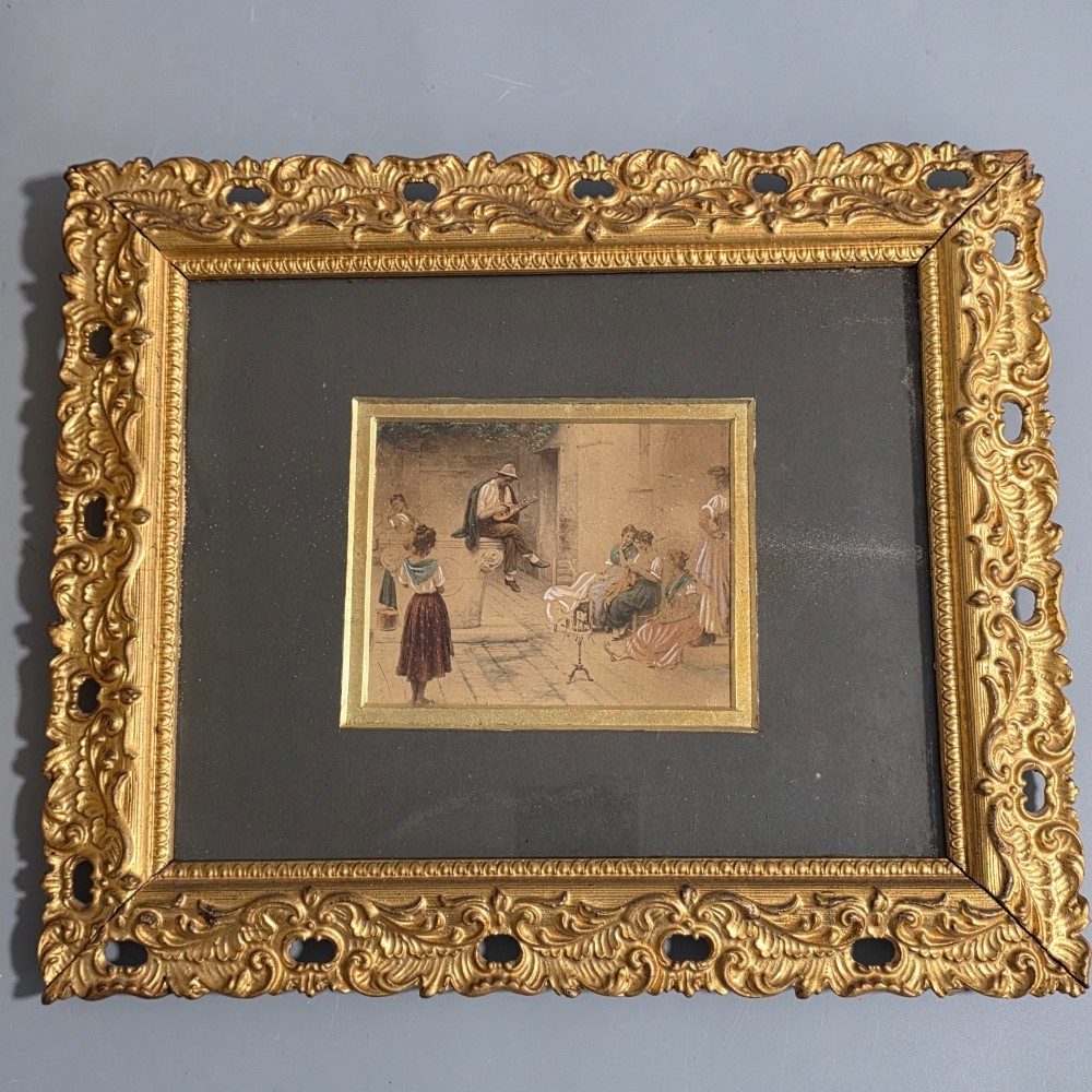 A pair of rectangular antique gilt-framed pictures featuring figurative genre scenes set against dark matting. View III