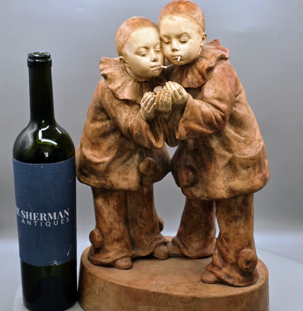 A terracotta sculpture featuring two Pierrot figures in ruffled collars standing together on an oval plinth, designed as a lamp base. View III