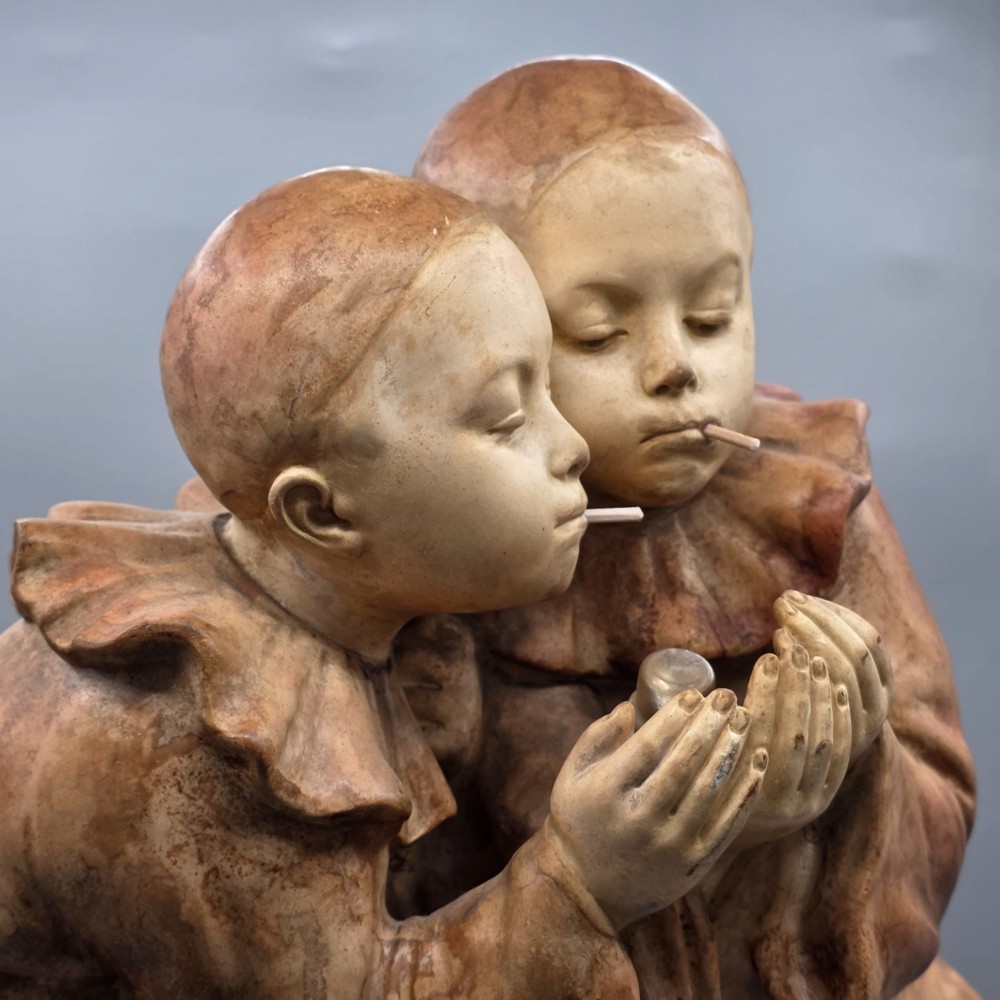 A terracotta sculpture featuring two Pierrot figures in ruffled collars standing together on an oval plinth, designed as a lamp base. View IV