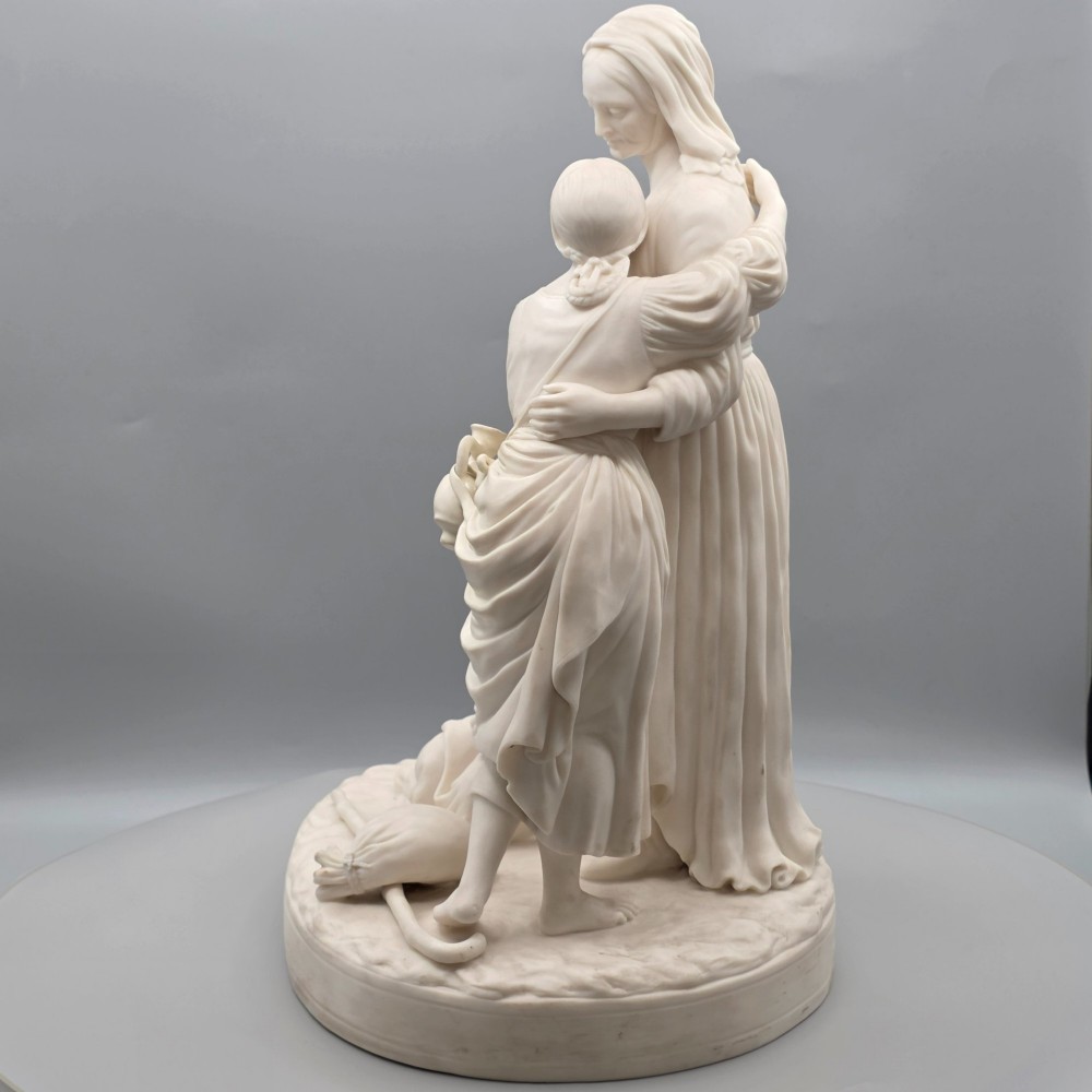 A Victorian off-white parian porcelain figural group depicting three women in classical draped robes on an oval base. View IV