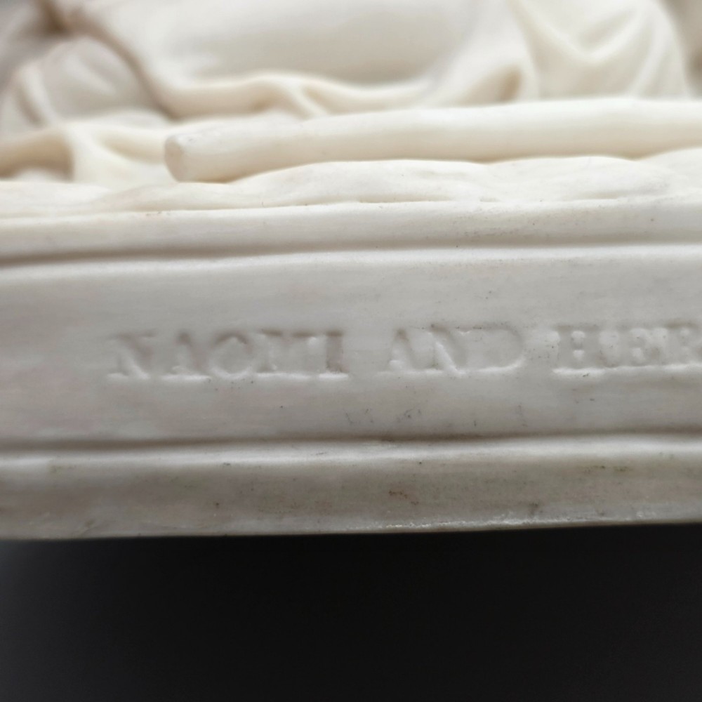 A Victorian off-white parian porcelain figural group depicting three women in classical draped robes on an oval base. View XI