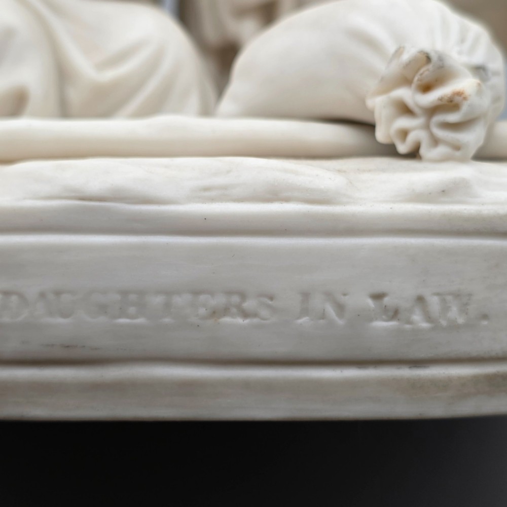 A Victorian off-white parian porcelain figural group depicting three women in classical draped robes on an oval base. View XII
