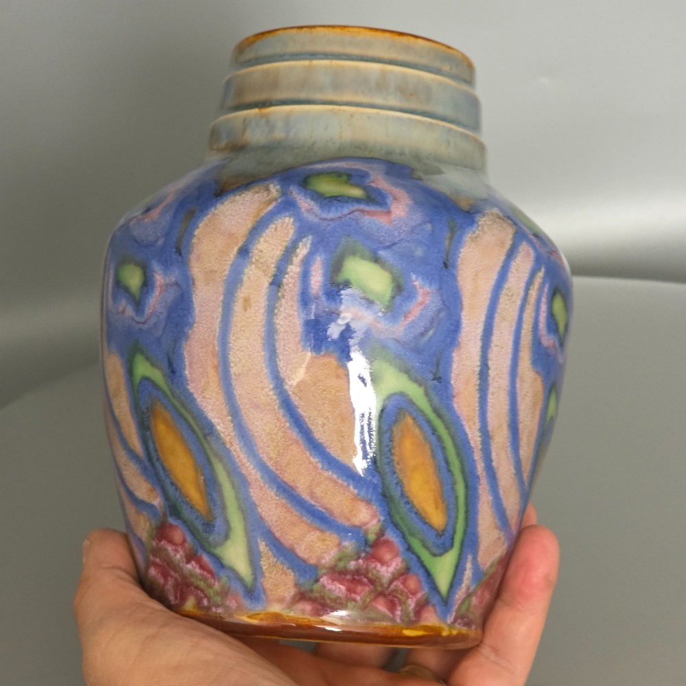 An Art Nouveau baluster-shaped stoneware vase with a stepped rim, featuring vibrant blue, pink, green, and ochre glazes forming abstract floral motifs. View XIV