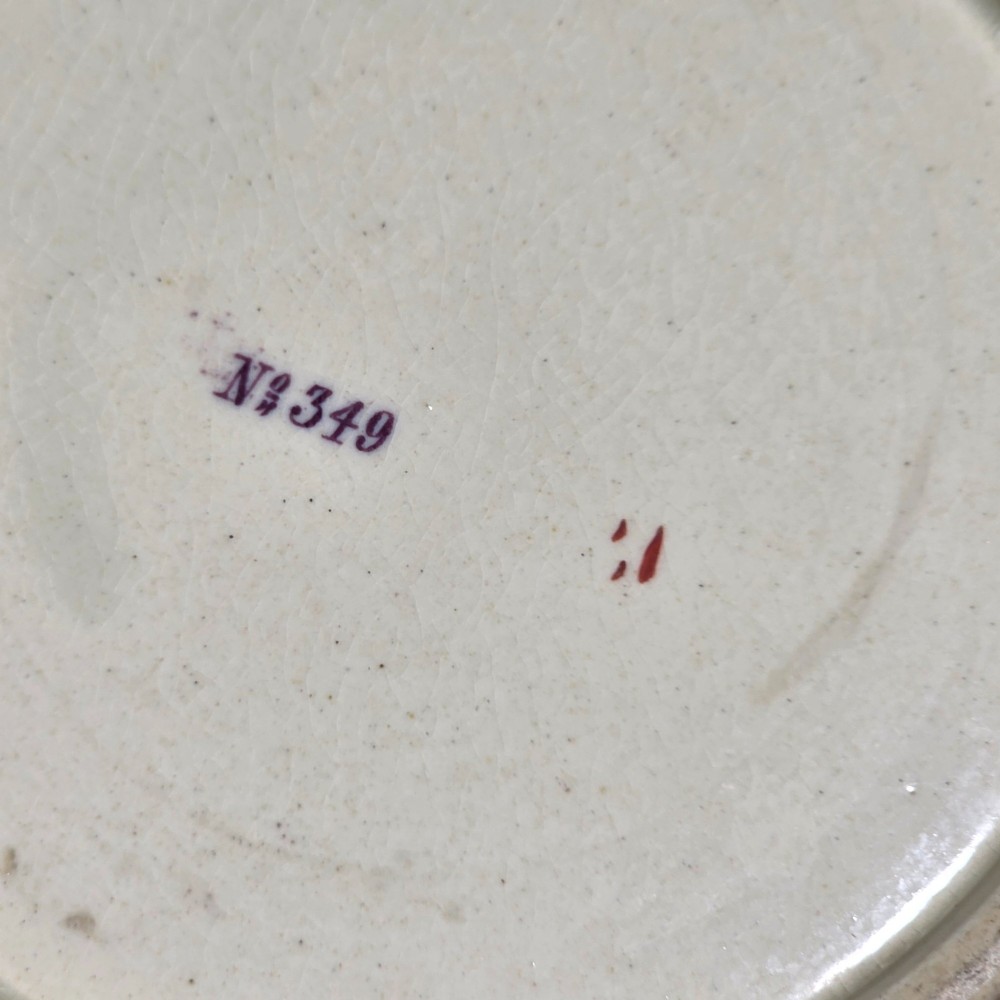 A large cream porcelain mug decorated with hand-painted polychrome birds, insects, flowers, and a gilded rim. View XII