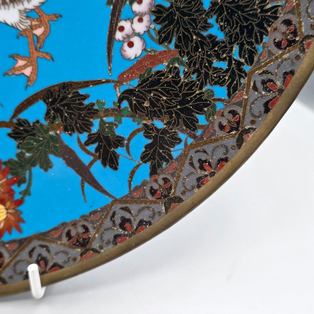 A circular Japanese cloisonne enamel charger depicting three wild geese amidst chrysanthemums against a vivid turquoise background. View V