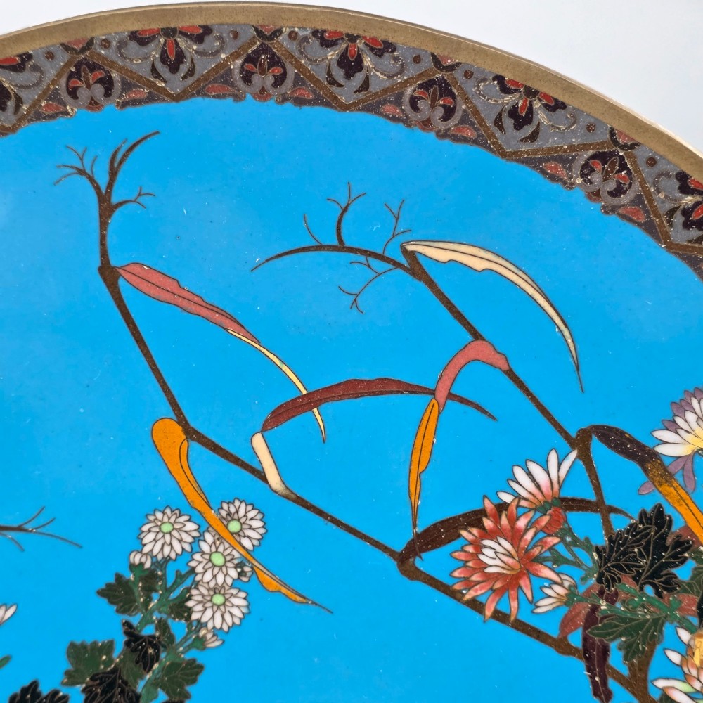 A circular Japanese cloisonne enamel charger depicting three wild geese amidst chrysanthemums against a vivid turquoise background. View VI