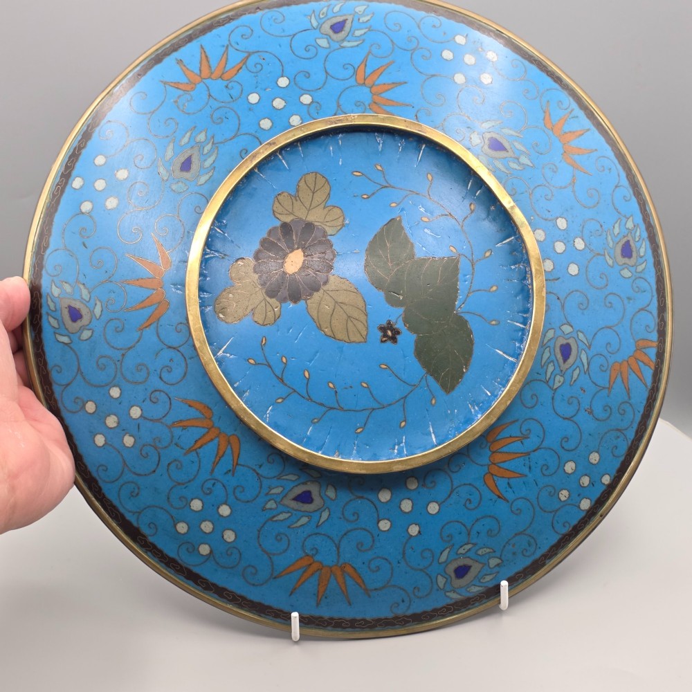 A circular Japanese Meiji period cloisonne enamel charger depicting birds perched on branches with flowers against a bright blue background. View II