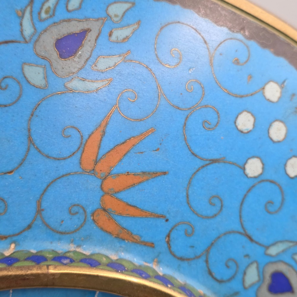 A circular Japanese Meiji period cloisonne enamel charger depicting birds perched on branches with flowers against a bright blue background. View XII