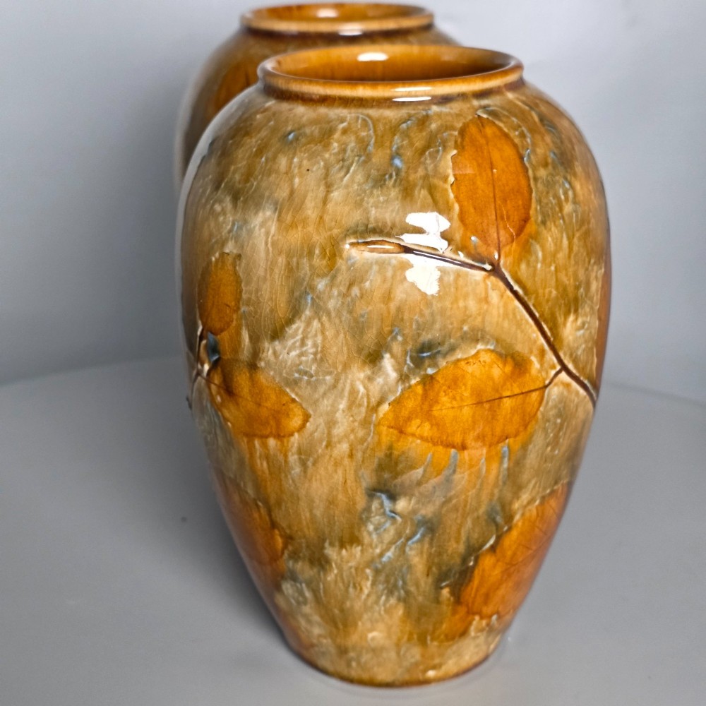 A pair of Edwardian baluster-shaped stoneware vases with warm ochre glaze and impressed leaf motifs. View III
