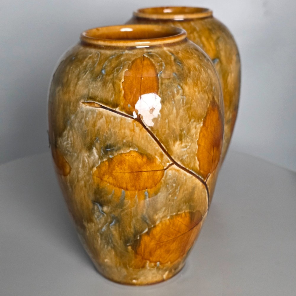 A pair of Edwardian baluster-shaped stoneware vases with warm ochre glaze and impressed leaf motifs. View IV