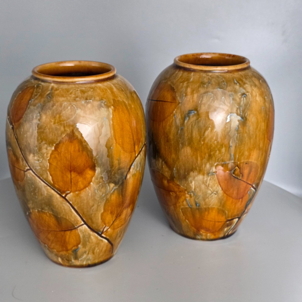 A pair of Edwardian baluster-shaped stoneware vases with warm ochre glaze and impressed leaf motifs. View VII