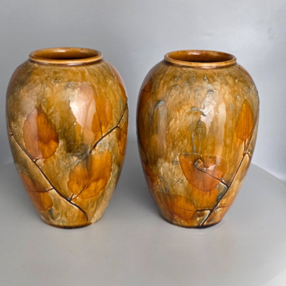 A pair of Edwardian baluster-shaped stoneware vases with warm ochre glaze and impressed leaf motifs. View VIII