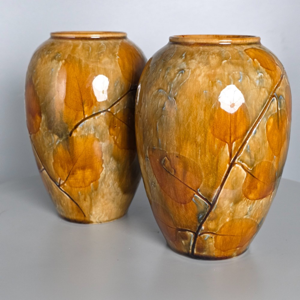 A pair of Edwardian baluster-shaped stoneware vases with warm ochre glaze and impressed leaf motifs. View XII