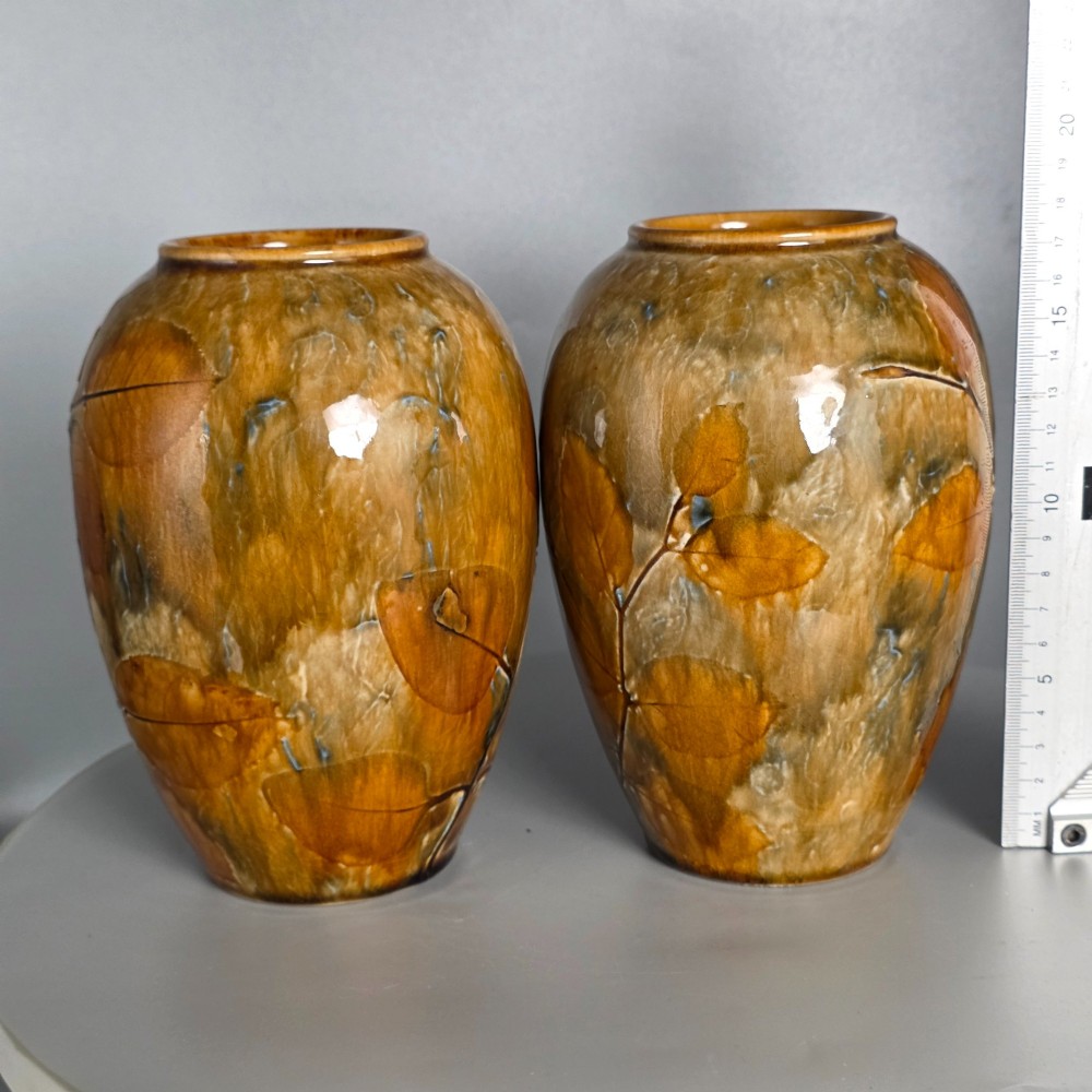 A pair of Edwardian baluster-shaped stoneware vases with warm ochre glaze and impressed leaf motifs. View XIV
