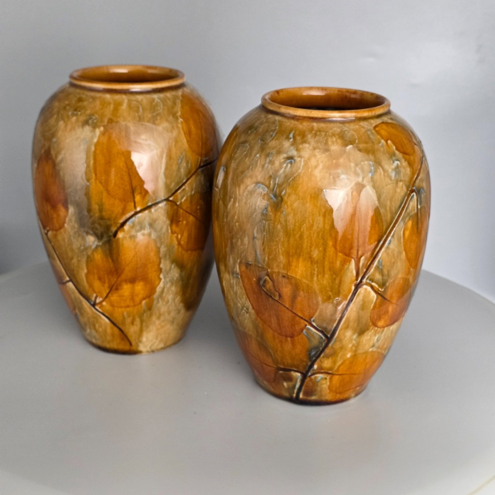 A pair of Edwardian baluster-shaped stoneware vases with warm ochre glaze and impressed leaf motifs. View XV