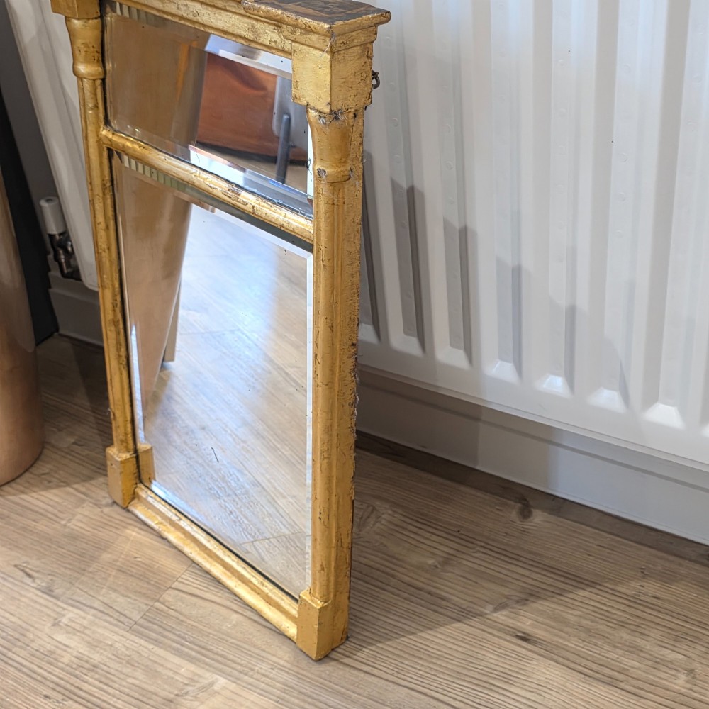 A rectangular Regency style giltwood pier mirror featuring side columns, an architectural cornice, and a two-section glass mirror plate. View V