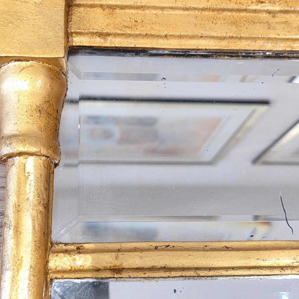A rectangular Regency style giltwood pier mirror featuring side columns, an architectural cornice, and a two-section glass mirror plate. View IX