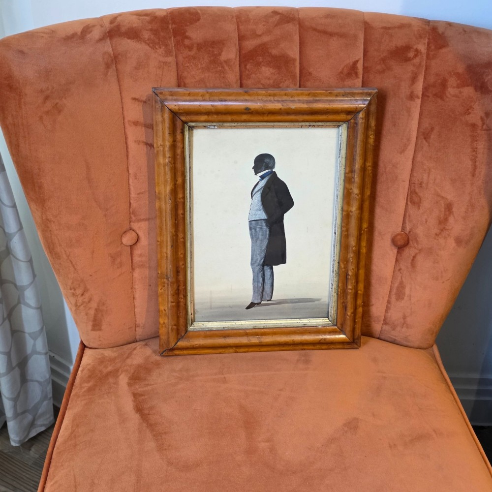 A framed full-length silhouette portrait of a gentleman in 19th-century costume presented in a birds eye maple frame. View III