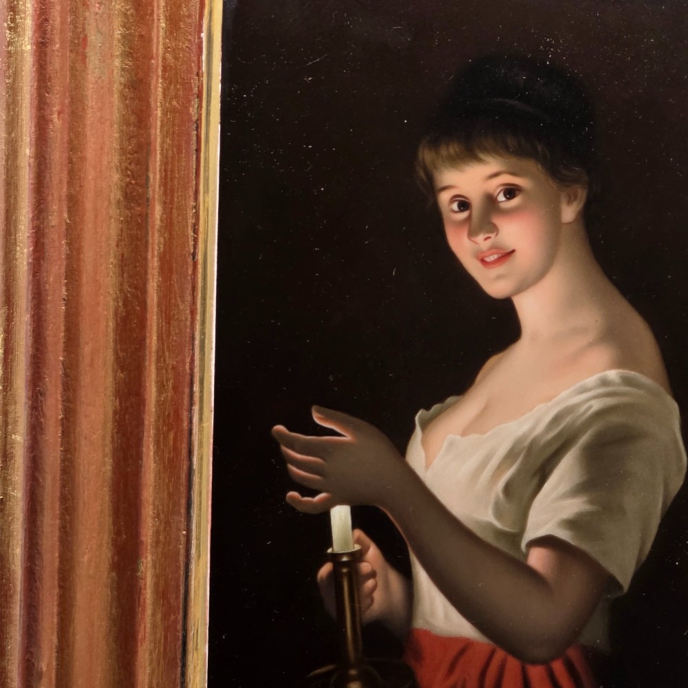 A nineteenth-century framed hand-painted KPM porcelain plaque featuring a young woman holding a lit candle against a dark background. View II