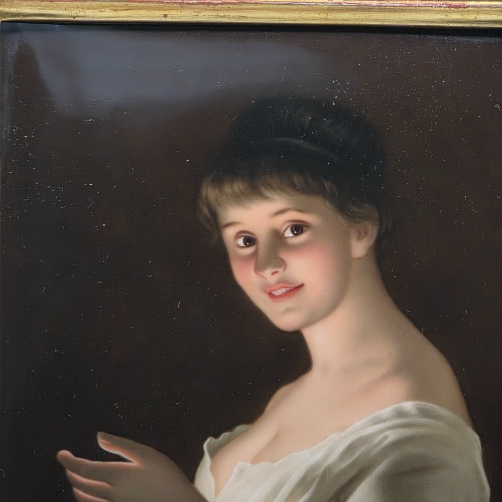 A nineteenth-century framed hand-painted KPM porcelain plaque featuring a young woman holding a lit candle against a dark background. View III