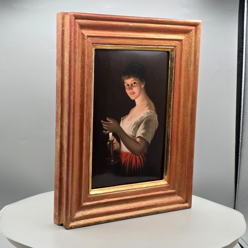 A nineteenth-century framed hand-painted KPM porcelain plaque featuring a young woman holding a lit candle against a dark background. View IV