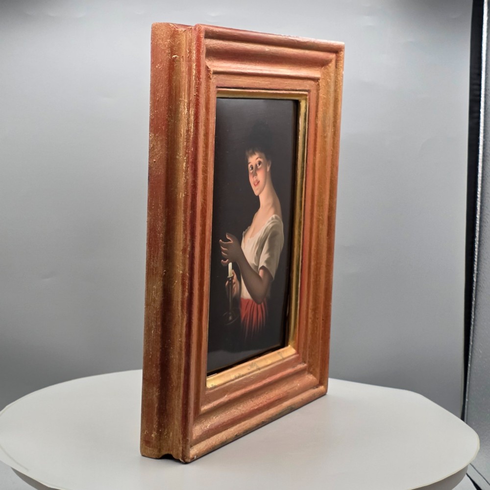 A nineteenth-century framed hand-painted KPM porcelain plaque featuring a young woman holding a lit candle against a dark background. View VI