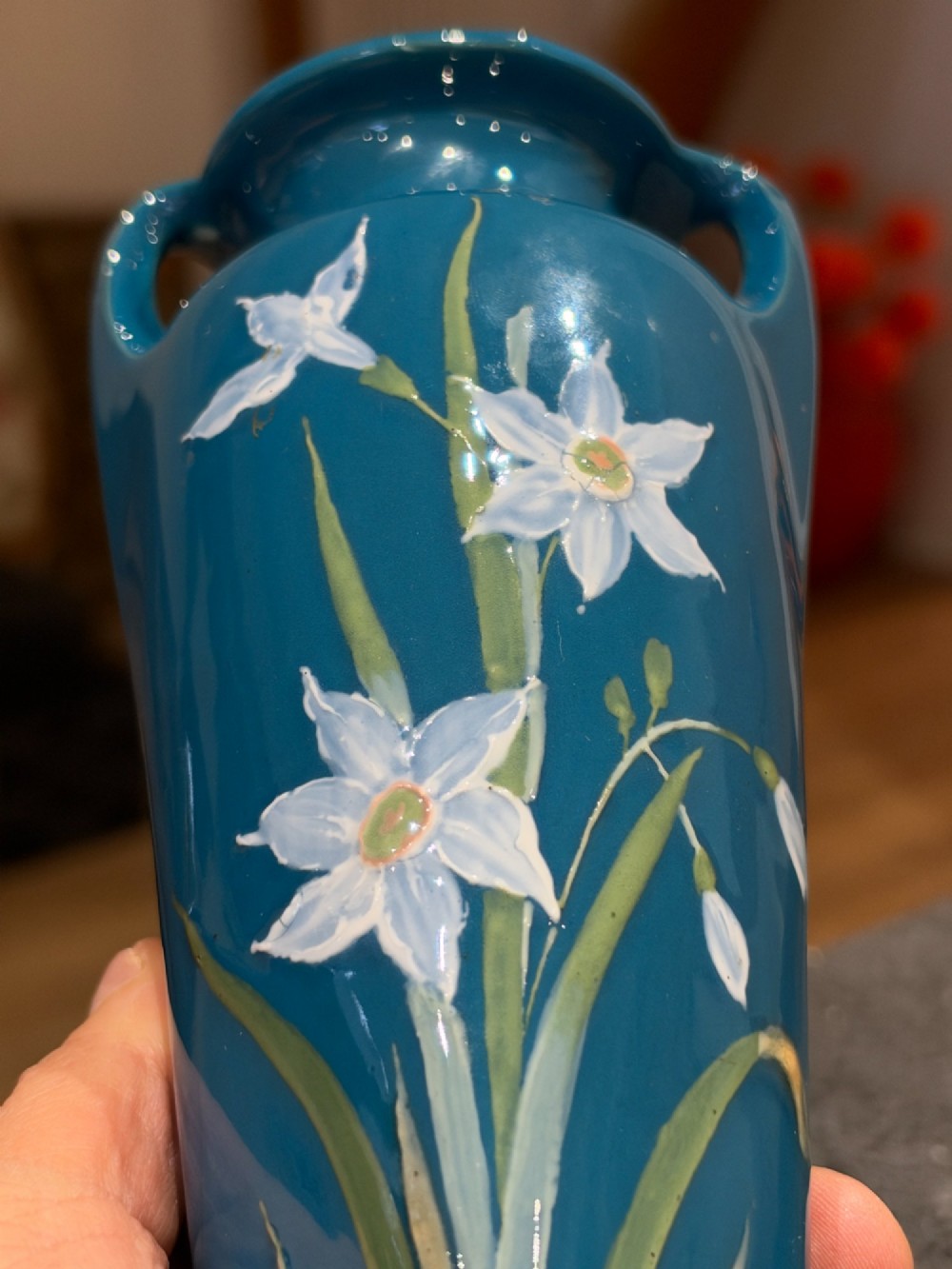 A tapered teal blue porcelain vase featuring twin loop handles and white pate-sur-pate floral relief decoration. View VI