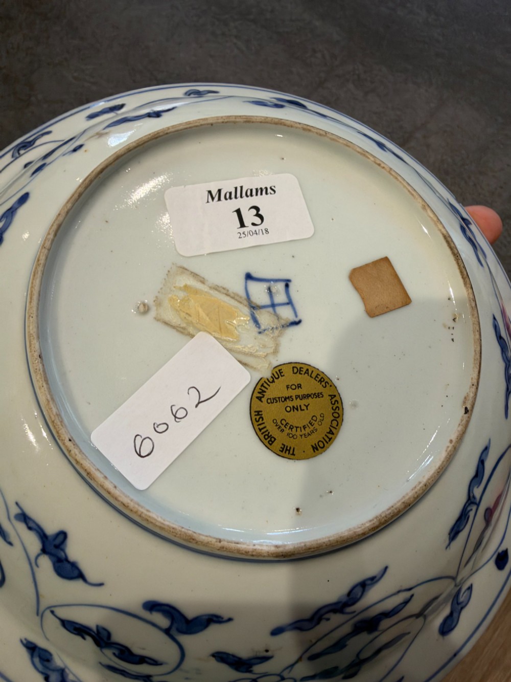 A circular 17th-century Chinese Kraak porcelain dish featuring underglaze cobalt blue panelled decoration surrounding a central landscape reserve. View XI