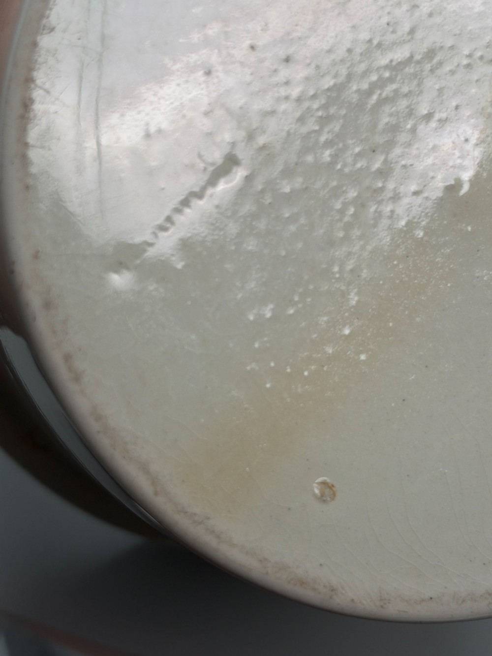 A set of three graduated off-white ceramic cylindrical vessels featuring dark iron bands around the upper rims and extended iron handles. View IX