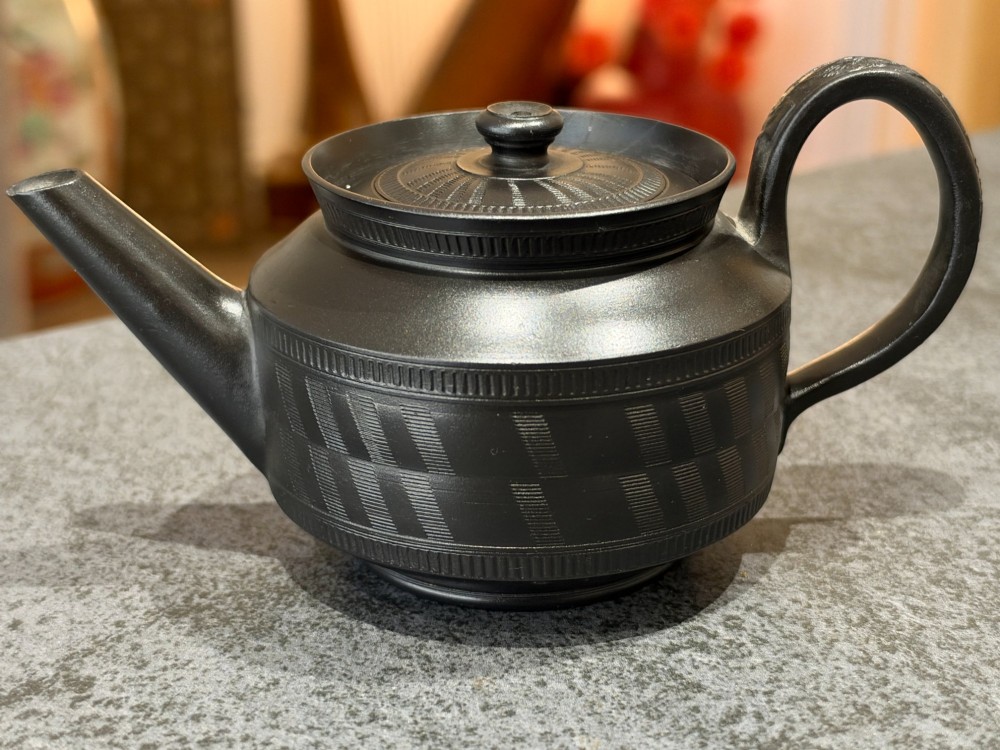 A matte black Georgian basalt stoneware teapot featuring engine-turned geometric band pattern detail and a decorative moulded handle. View XI