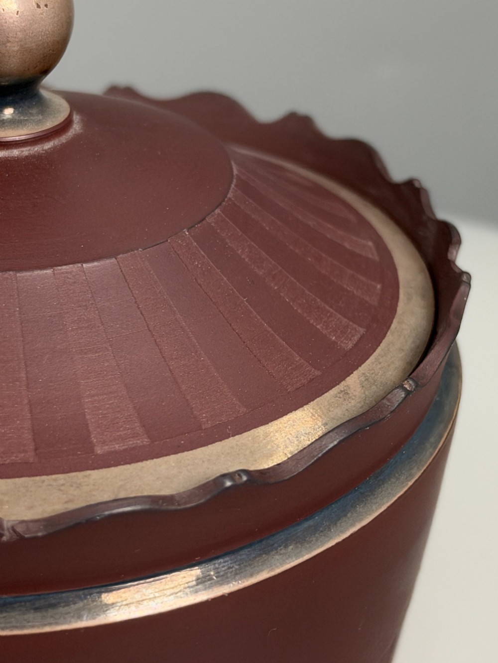 An 18th-century terracotta-coloured red stoneware sugar basin and lid with engine-turned vertical fluting and a metal ball finial. View X