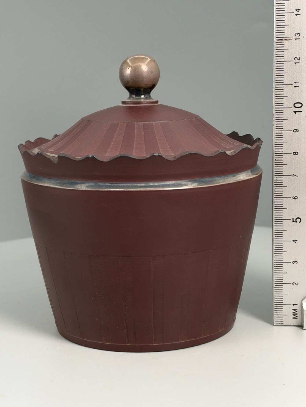 An 18th-century terracotta-coloured red stoneware sugar basin and lid with engine-turned vertical fluting and a metal ball finial. View XIV