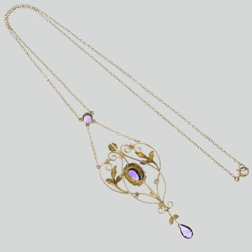 fig 2. An Edwardian 9ct gold openwork lavalier pendant set with oval and pear-cut amethysts and seed pearls on a chain.