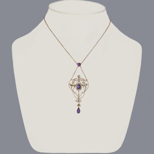 fig 3. An Edwardian 9ct gold openwork lavalier pendant set with oval and pear-cut amethysts and seed pearls on a chain.