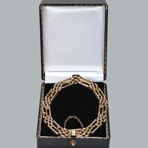 fig 2. A circular Victorian 15ct yellow gold gate link bracelet set with split pearls and featuring a safety chain.