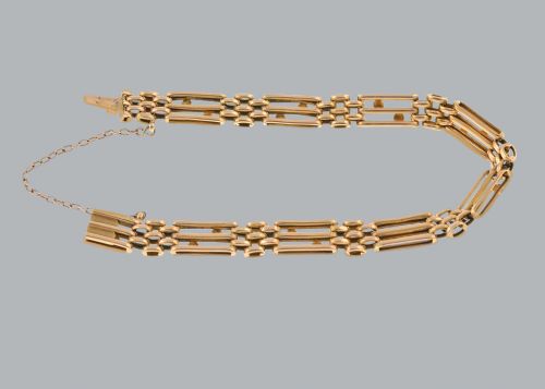 fig 4. A circular Victorian 15ct yellow gold gate link bracelet set with split pearls and featuring a safety chain.