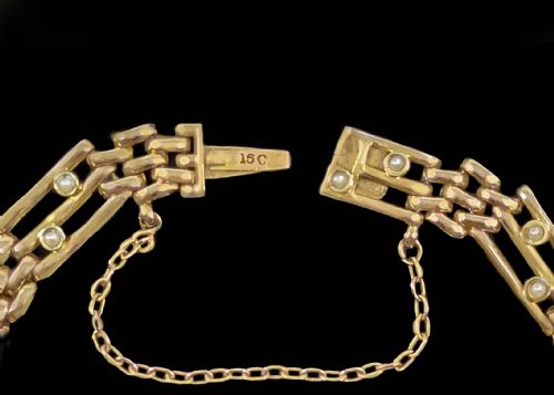 fig 5. A circular Victorian 15ct yellow gold gate link bracelet set with split pearls and featuring a safety chain.