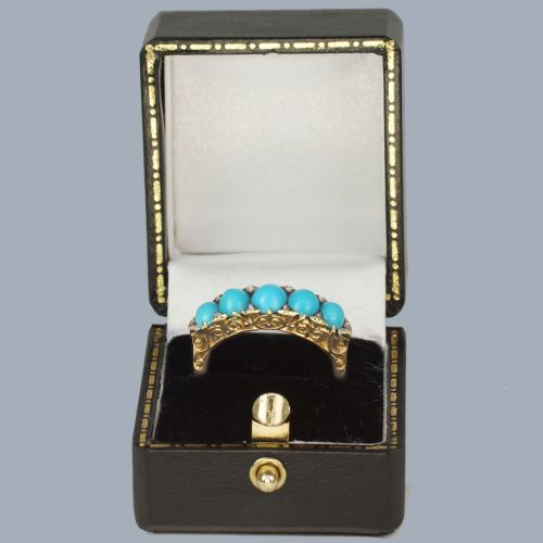 fig 5. An 18ct yellow gold Victorian ring set with five graduated cabochon turquoise stones punctuated by small diamond points.