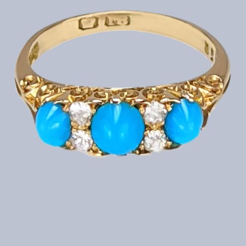 fig 5. An 18ct yellow gold late Victorian ring featuring three dome-shaped blue turquoise cabochons accented by small old cut diamonds set within a carved scrollwork gallery.