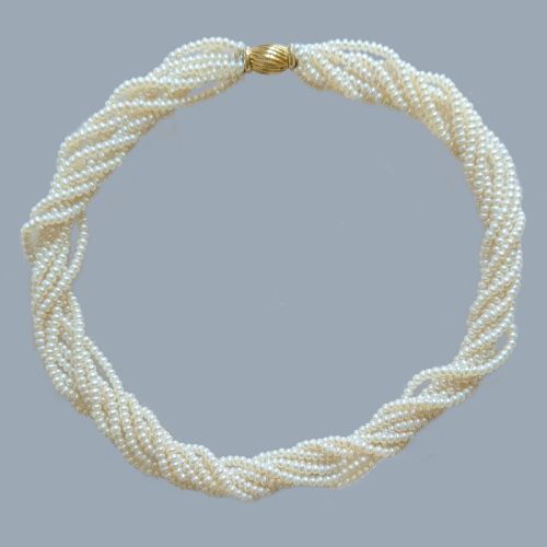 fig 2. An eight-strand freshwater seed pearl necklace with a fluted yellow gold barrel clasp.