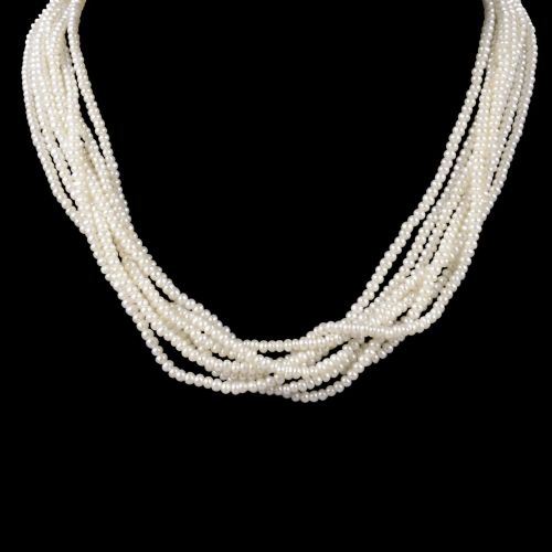 fig 8. An eight-strand freshwater seed pearl necklace with a fluted yellow gold barrel clasp.