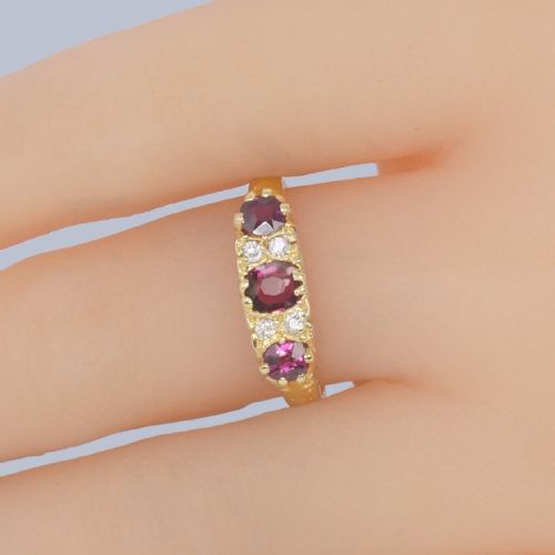 fig 1. A Late Victorian 18ct yellow gold carved gallery ring set with three oval rubies and four small old cut diamonds.