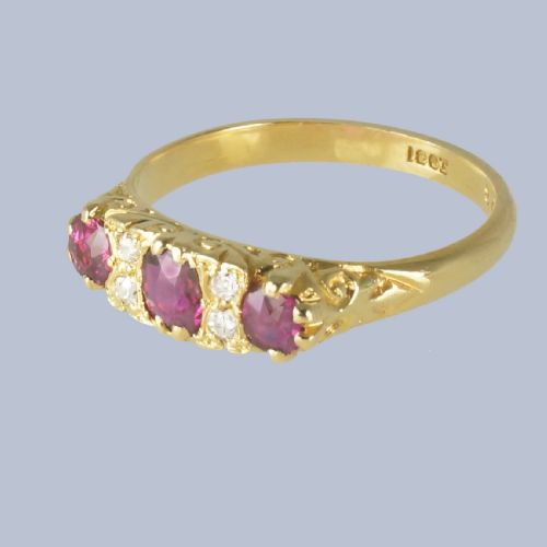 fig 4. A Late Victorian 18ct yellow gold carved gallery ring set with three oval rubies and four small old cut diamonds.