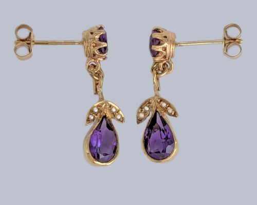 fig 1. Pair of 9ct gold drop earrings featuring round and pear-cut faceted purple amethysts accented with small seed pearl leaf details.
