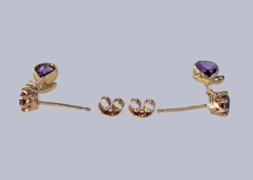 fig 4. Pair of 9ct gold drop earrings featuring round and pear-cut faceted purple amethysts accented with small seed pearl leaf details.