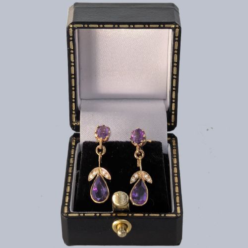 fig 5. Pair of 9ct gold drop earrings featuring round and pear-cut faceted purple amethysts accented with small seed pearl leaf details.