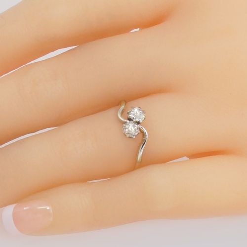 fig 1. An Edwardian two-stone crossover ring featuring two old-cut diamonds set in platinum claws on an eighteen-carat yellow gold band.